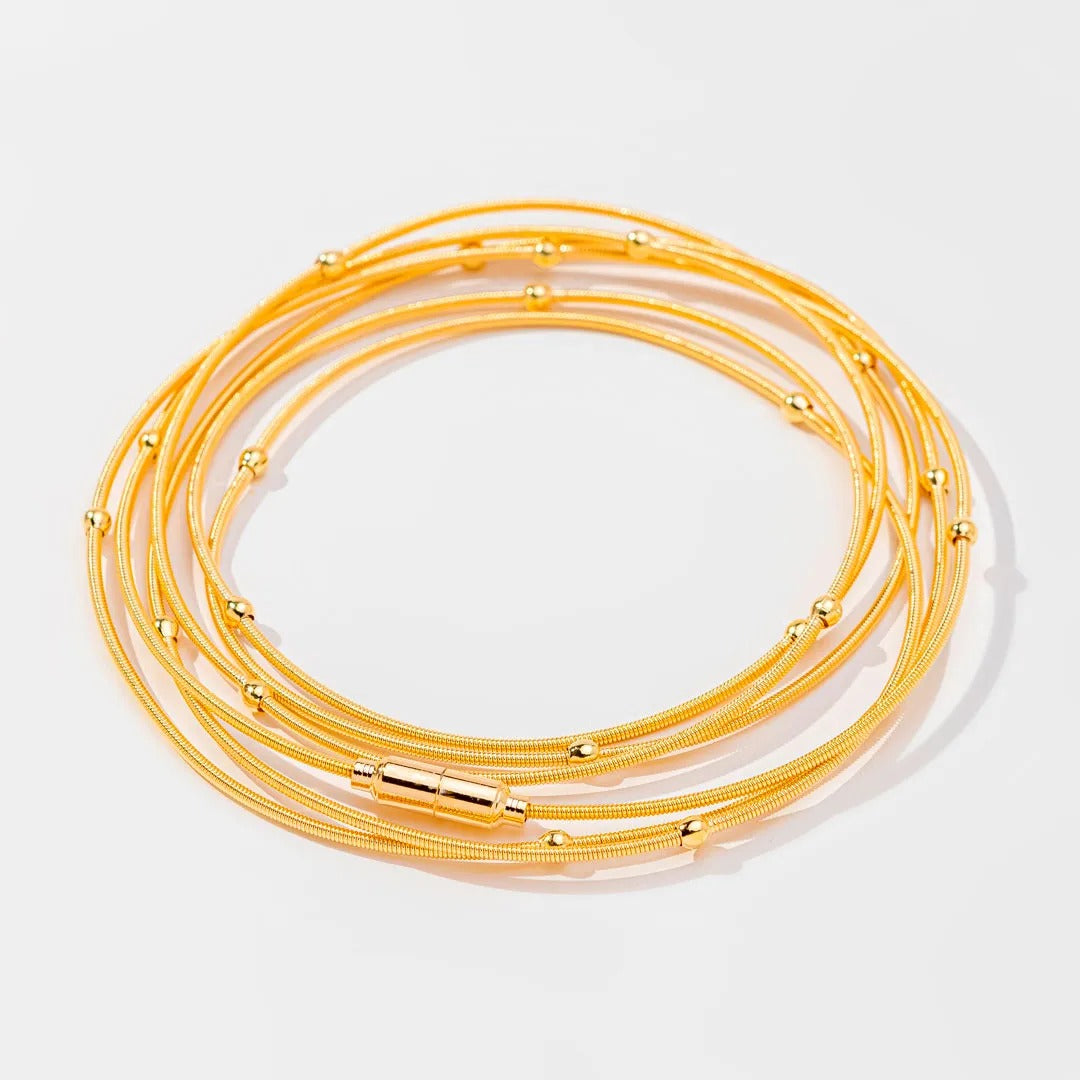Pulseira corda de violão com bolinhas banhada a ouro 18k